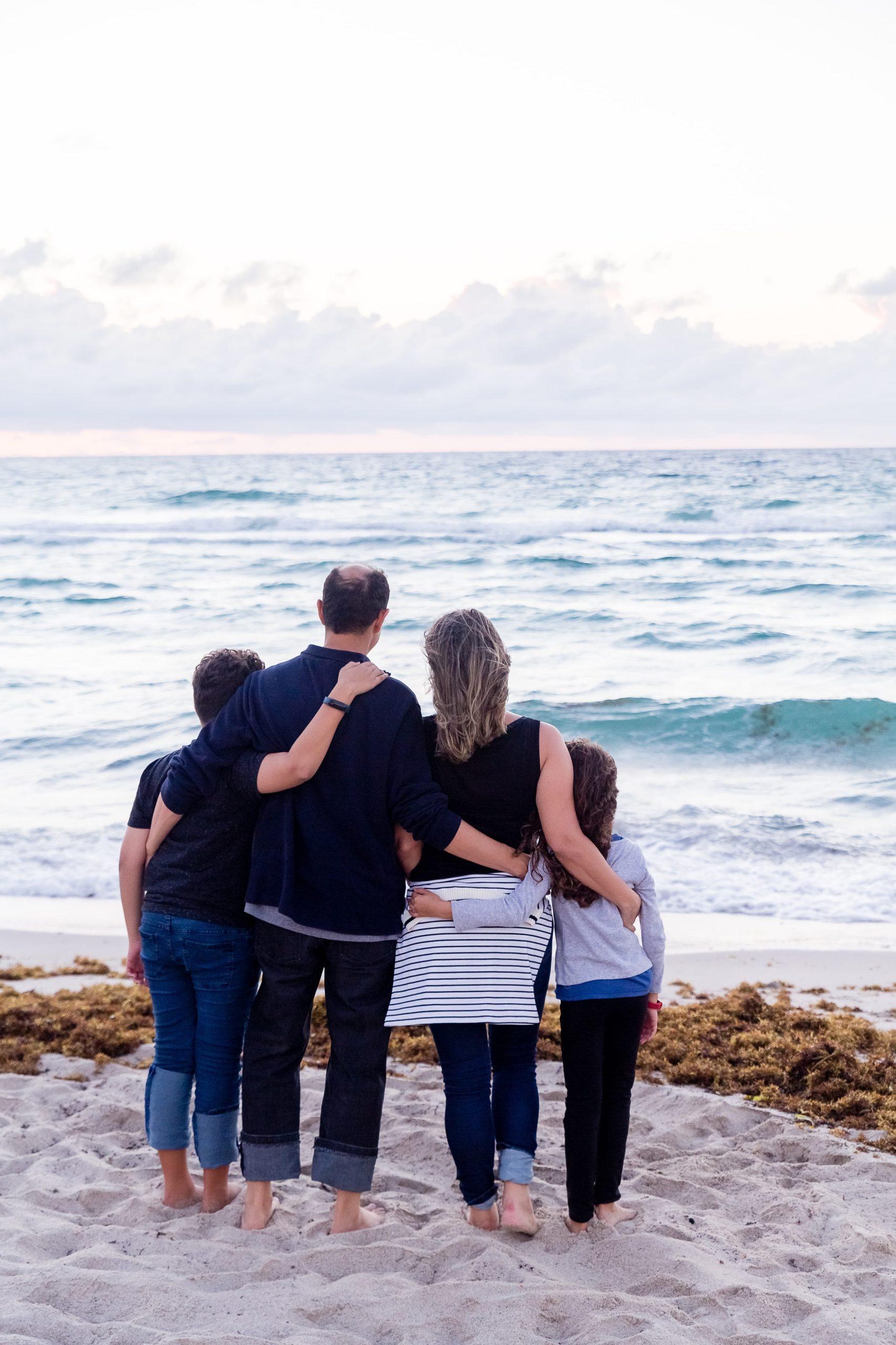 A family near the ocean on a family getaway to Europe