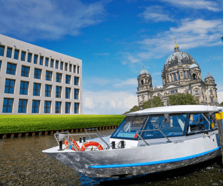 A boat passing Berlin cathedral, one of the must-see sightse during Berlin city break