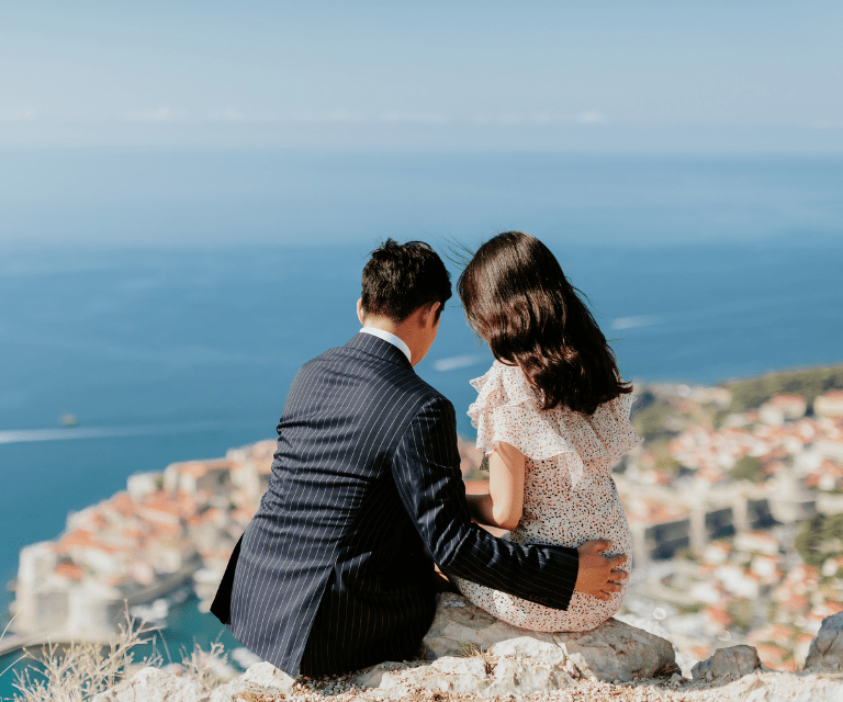 A couple is cuddling, admiring the stunning views of Dubrovnik on their romantic weekend break to Dubrovnik