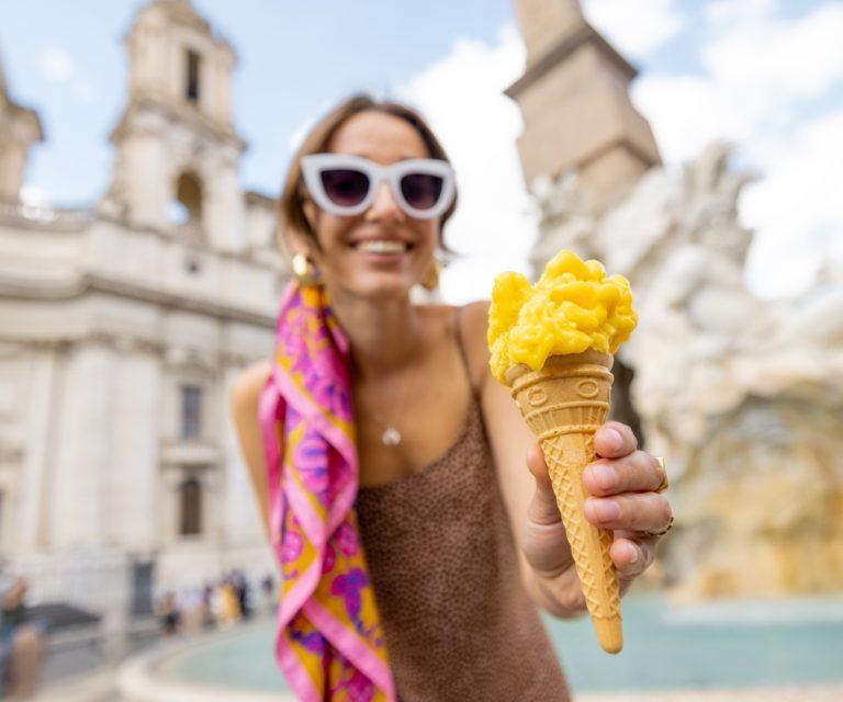 A woman is offering an ice-cream in Rome
