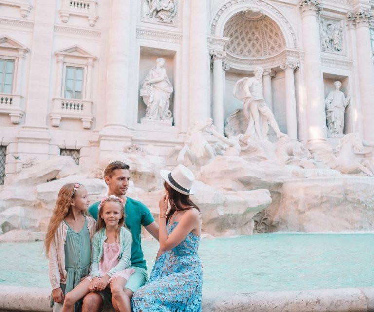 A family in front of Trevi Fountain, Rome