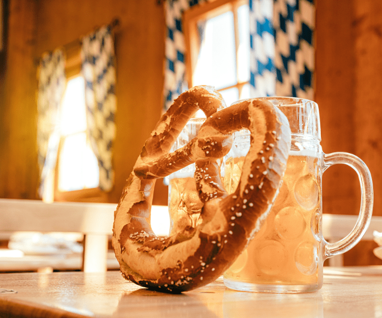 A traditional Bavarian pretzel and a dimpled mug of beer, must-tries during a Munich city break