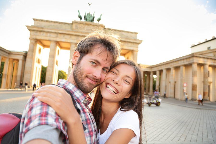 A couple near the Brandenburg Gate during their romantic city break
