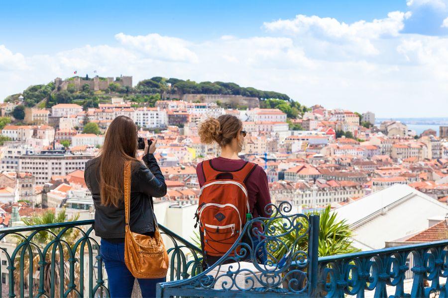 2 friends are enjoying the views of the city during their city break to Lisbon