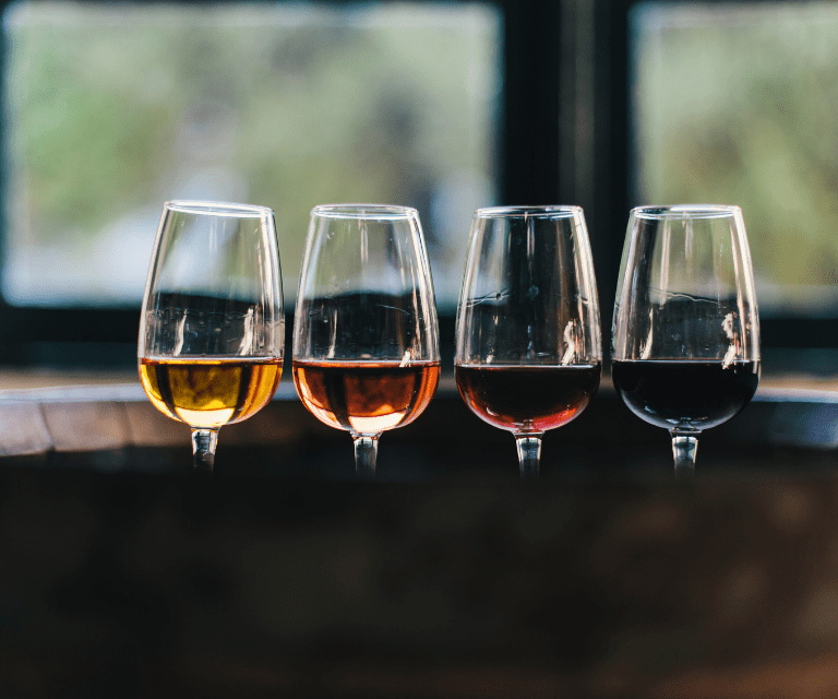 four glasses of Porto wine, a must-try thing during the getaway to Portugal