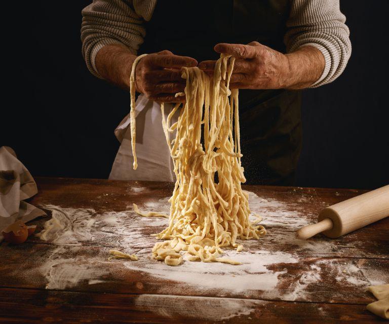a man cooking pasta from scratch