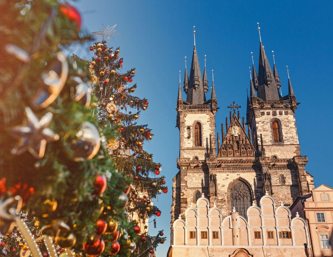 Stunning Christmas tree near the Church of Our Lady Tyn on a clear winter day, a must-see sight during a christmas weekend break to Prague