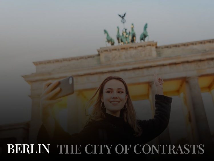 A woman taking a selfie near the Brandenburg Gate, a must-visit place during a Berlin getaway