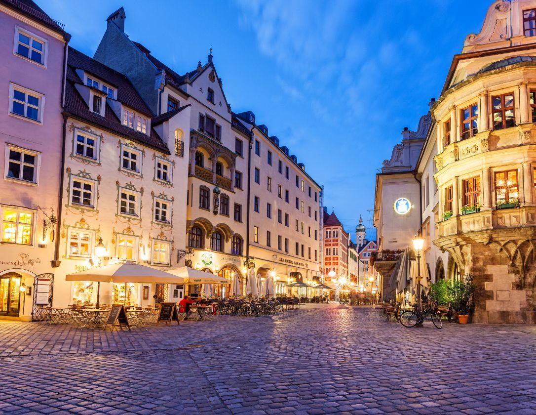 The beautifully lit restaurants on Platz Square, a popular place among toursits on their Munich city break