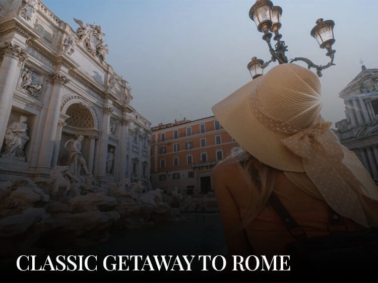A woman admiring the Trevi fountain during her weekend getaway to Rome