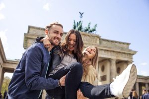 A group of friends laughing near the Brandenburg Gate