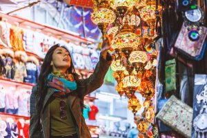 A young woman is checking out one of the stalls on Grand Bazaar, a must-visit place during a city break to Turkey