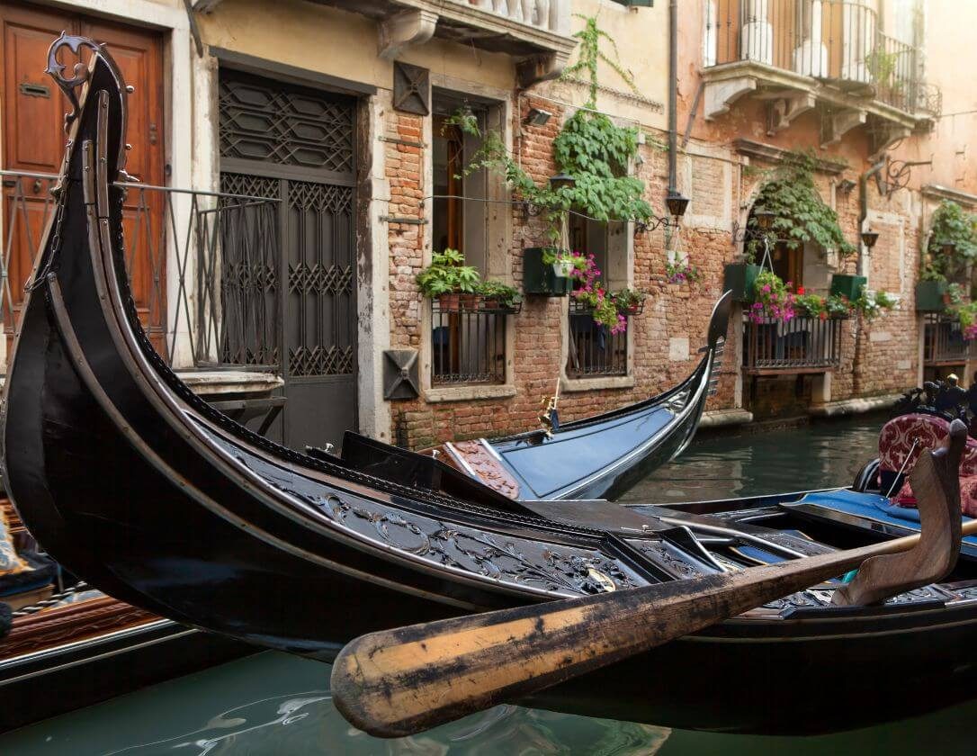 Black gondola on a Venice canal, a must-see sight on a family break to Venice