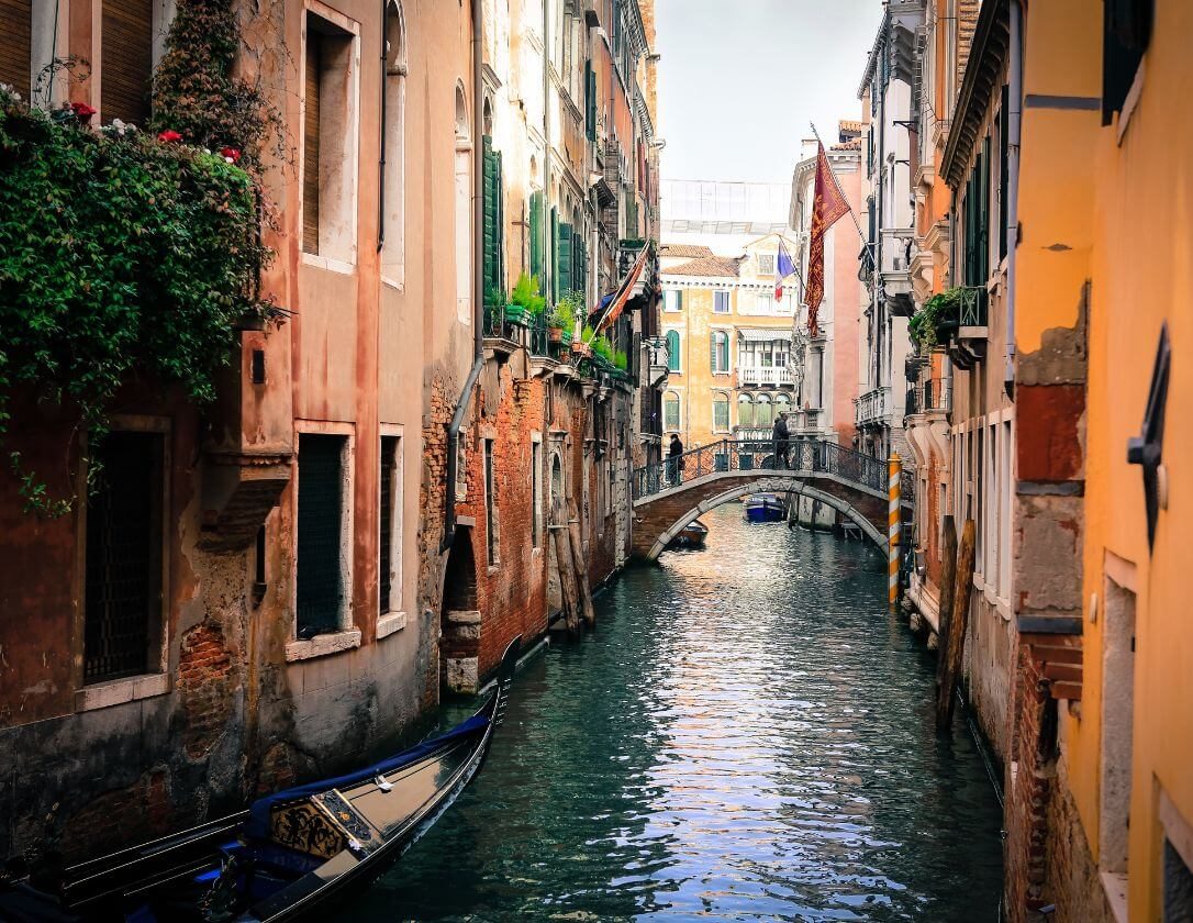 Stunning views of the narrow canals surrounded by beautiful orange houses, a must-see sight on a break to Venice
